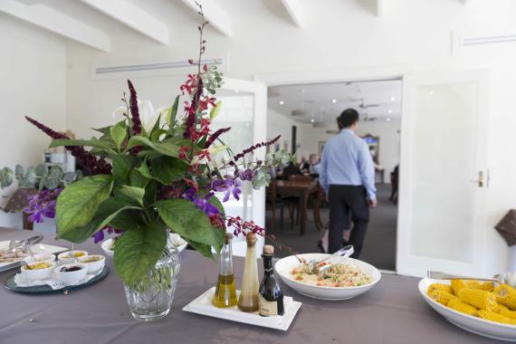 AIPM Venue - photo of lunch with bright flower arrangement 