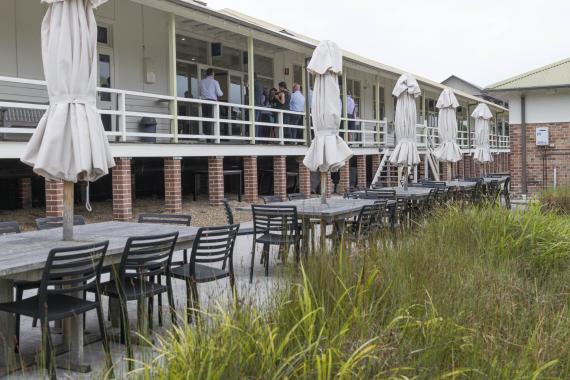 AIPM Venue - External photo of outdoor eating area with closed umbrellas