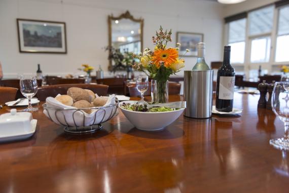 AIPM Venue - Photo of bread rolls, salad and wine.