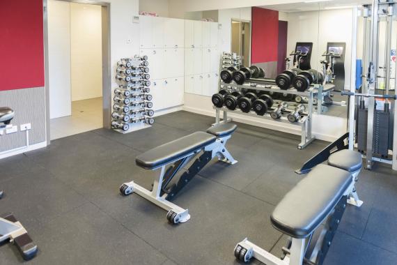 AIPM Venue - photo of gym showing two benches and weights in the background